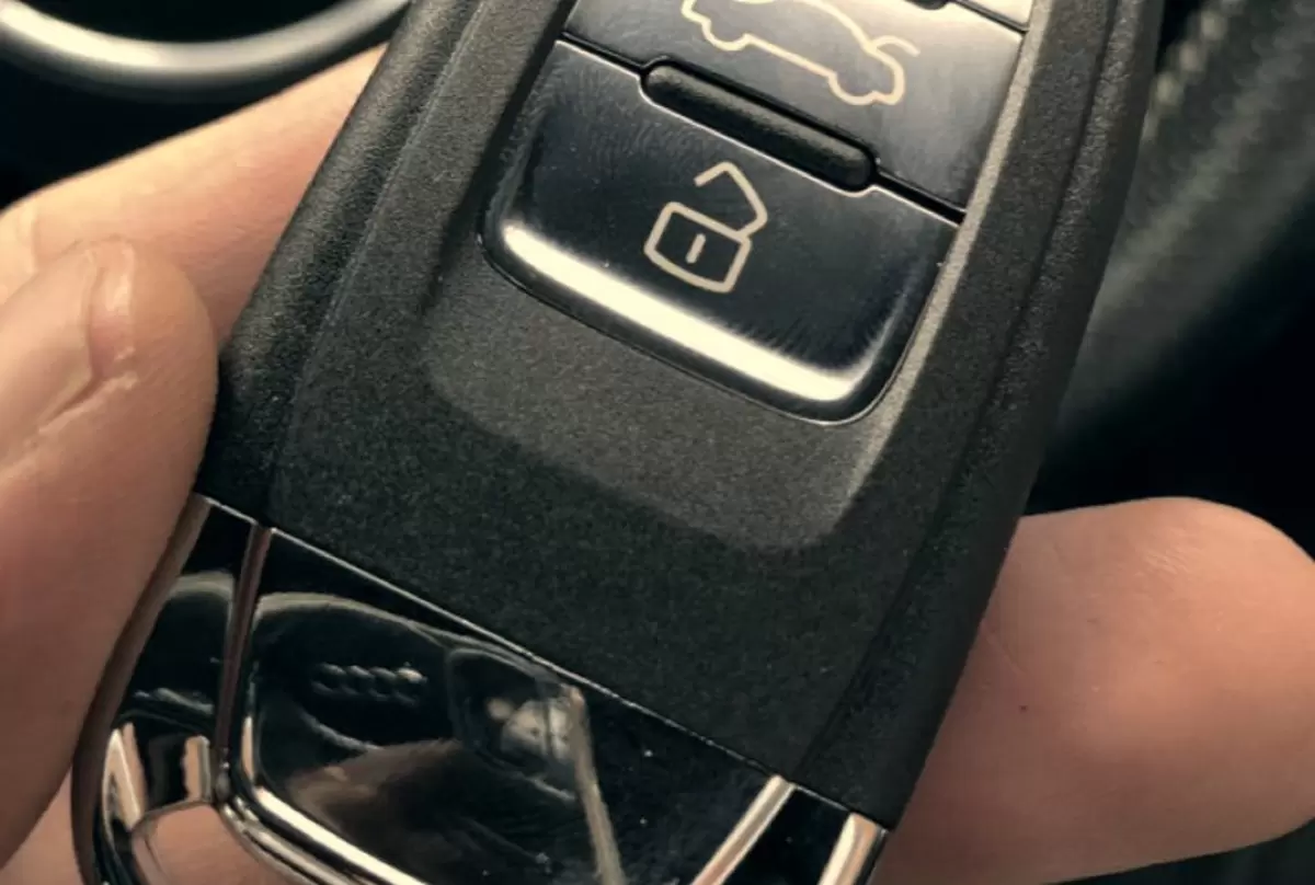 Close-up of a replacement Audi proximity smart key, lock and boot buttons in focus.